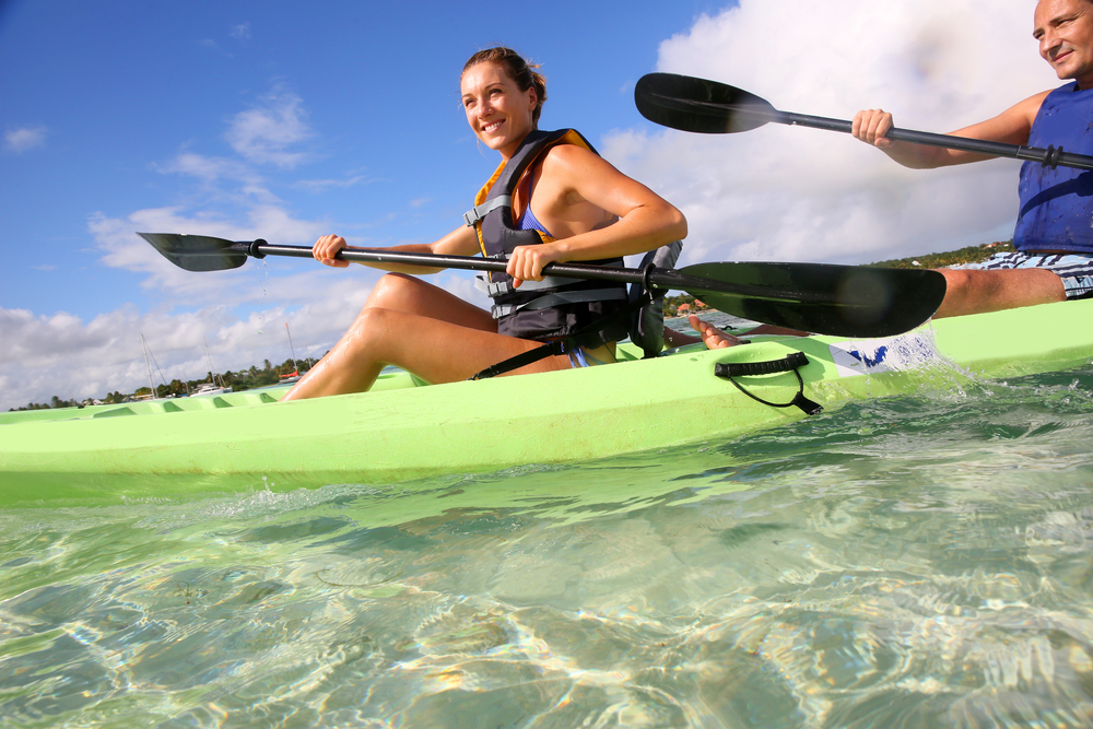 Couple canoeing in lagoon of West French indies-1